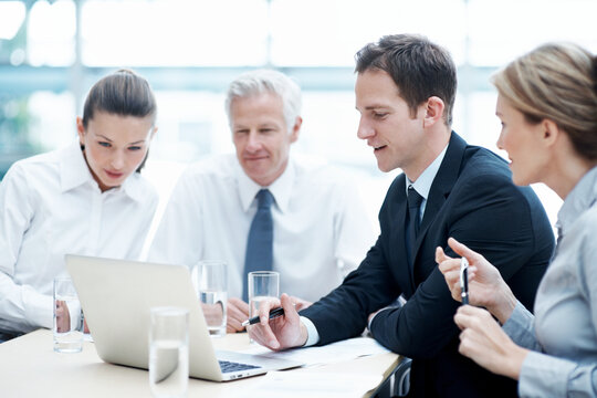 Corporate, people and manager at law firm with laptop, paralegal and lawyer research for litigation. Attorney, team and conversation in office with computer, strategy and administration for lawsuit.