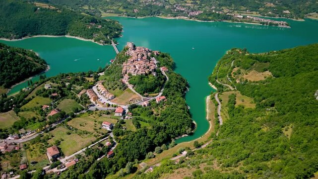 Castel di Tora Aerial Top-Down Drone View Stunning Lake Turano Curves and Medieval Bridge Authentic Hidden Paradise in Italy Scenic Peninsula Ancient Borgo Landscape Majestic Emerald Water 4k footage