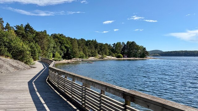 Wooden boardwalk curving along Oslo fjord in Son, Norway