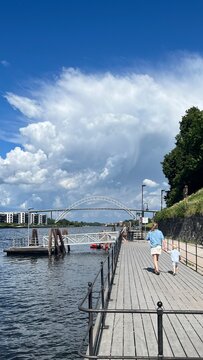 Family walking on boardwalk near Glomma river in Fredrikstad