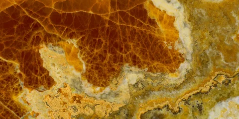 Elegant golden-yellow onyx marble texture featuring translucent layers and natural stone veining. © Vidal