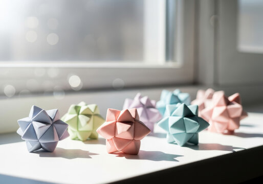Origami paper stars in pastel colors, decorative geometric 3D paper crafts on a sunny windowsill, colorful modular origami sculptures for home decor