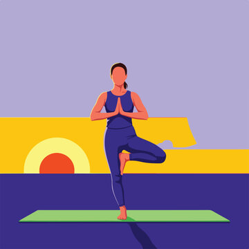 Woman practicing yoga tree pose on mat at sunset