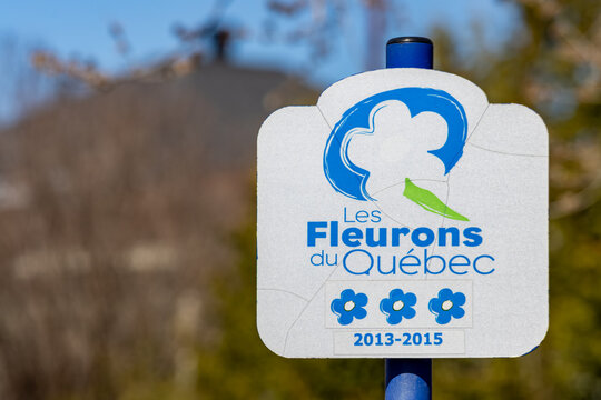Quebec, Canada, 26 April 2026 : Sign for Les Fleurons du Quebec horticultural recognition program displays three blue flower icons and dates -