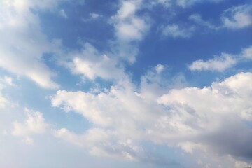 Fototapeta premium Beautiful blue sky background with fluffy white clouds on a sunny day