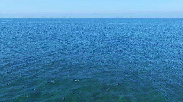 Aerial view of blue ocean under blue sky