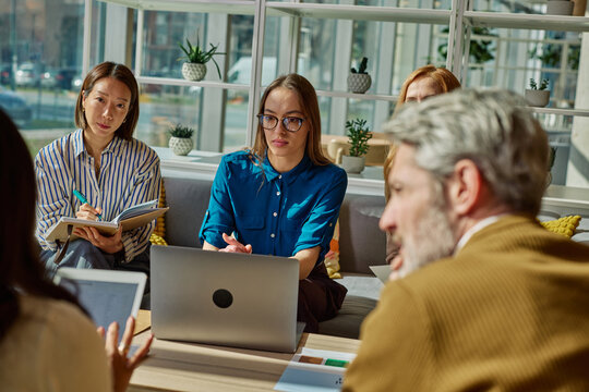 Business people having productive team meeting in modern office