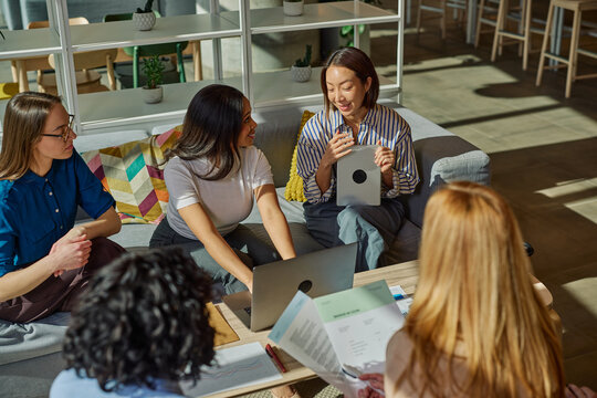 Diverse women collaborating planning business in modern office