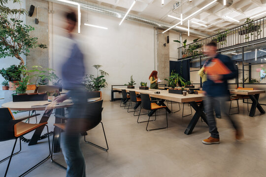 Blurry people moving in an open plan office