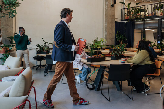 Diverse colleagues collaborating in modern green office