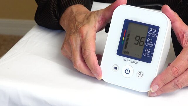 Senior veteran monitoring blood pressure as part of a routine healthcare wellness check promoting preventive care and healthy living