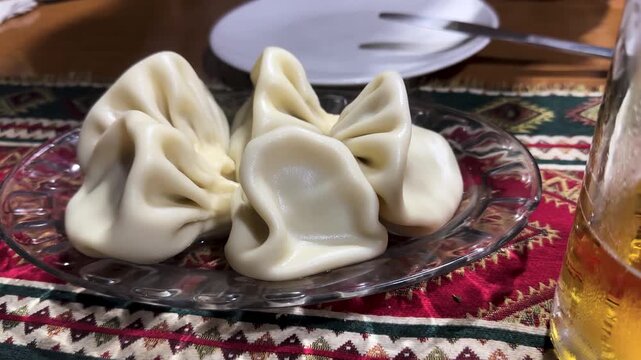 Traditional hot delicious khinkali is Georgian dumpling in mountain region savory seasoned meat vegetable pork beef in dough onion parsley garlic wine beer cozy restaurant local dish Caucasus recipe