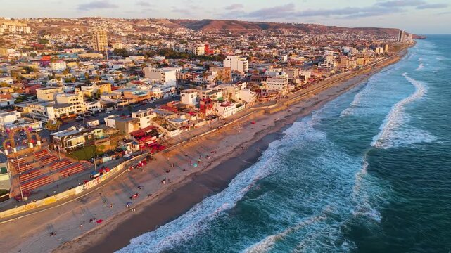 A magnificent golden hour aerial view of the Pacific surf washing onto the beaches of Playas de Tijuana, Mexico.