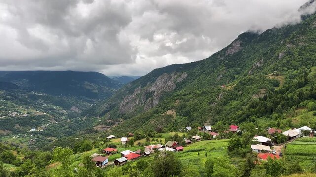 Cloudy sky pine forest in mountain village life local people harvest season landscape valley green riverside panoramic wild aerial view cabin Caucasus ecosystem cool temperate high altitude foothills