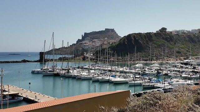 Castelsardo Italy Luxury yacht charter and sailing boats parked at a resort marina. High-end marine transport and elite ocean lifestyle travel destination.