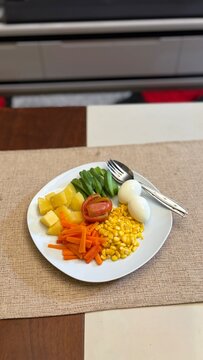 Delicious vegetable salad on white plate. High angle shot