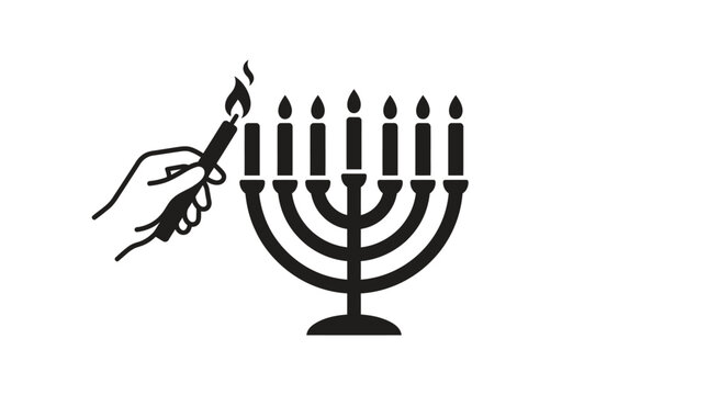 A hand lighting a traditional menorah candle for the Jewish holiday of Hanukkah.