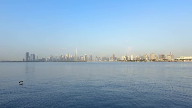 Wide panoramic view of Downtown Dubai and Burj Khalifa across Dubai Creek. Iconic waterfront skyline remains one of most recognized travel destinations in United Arab Emira