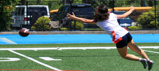 Girl Diving For Football During a Flag Football Game © coachwood