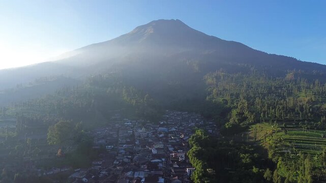 Aerial drone footage showcasing the majestic landscape of Mount Sindoro, an active stratovolcano and the second-highest volcano in Central Java, Indonesia.