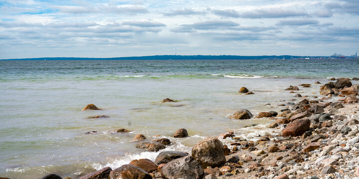 Rocky east coast of denmark with view the port of aarhus on horizon.