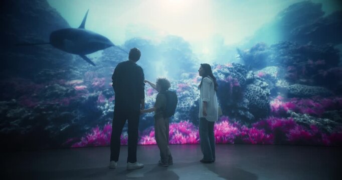 Oceanarium Marine Mammal Park Amazes a Family of Three as Mom, Dad and Kid Stand Together Watching an Orca Swim Above Colorful Reefs, Learning About Ocean Wildlife and Conservation.