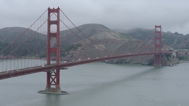 Golden Gate Bridge Aerial Drone Shot Revealing Both Towers And Stormy, Overcast Sky
