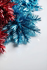 Fototapeta premium Red and blue tinsel on white background