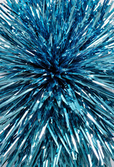 Fototapeta premium Blue metallic tinsel close-up on white background