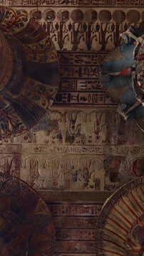 The temple of Esna, dedicated to the god Khnum. Egypt. Esna temple hypostyle hall with massive painted columns and colorful hieroglyphic reliefs on ceiling in Egypt, ancient Roman-era architecture wit