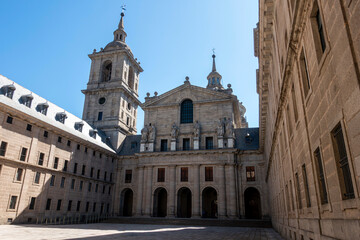 Fototapeta premium San Lorenzo del Escorial, Madrid,Spain;April 15, 2026: 16th-Century Renaissance Architecture of the Courtyard of the Kings with the Basilica Facade at the Royal Monastery of San Lorenzo de El Escorial