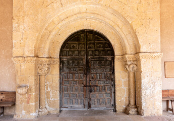 Fototapeta premium Romanesque Portal with Carved Archivolts and Decorated Wooden Door from the 12th to 13th Century Church of San Miguel in Sotosalbos, Segovia, Castile and Leon, Spain