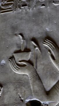 Ancient Egyptian wall relief with detailed hieroglyphs and figures depicting ritual scenes at the Abydos Temple, showcasing symbolic art and sacred traditions. Egypt
