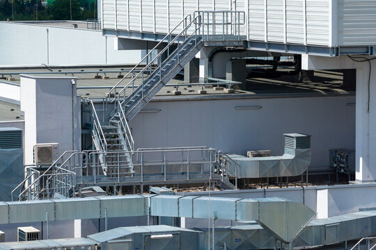 Aerial view of the AI data center rooftop featuring industrial ventilation systems, metal staircases, and HVAC units Warszawa, Mazowieckie, Poland.