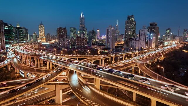 Day to night transition zoom in time lapse of busy elevated road intersection with commuters at night, Asia, China, Shanghai	
