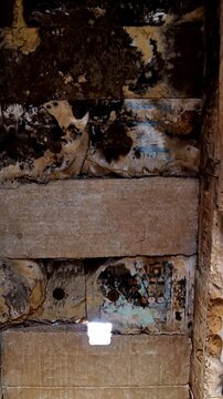Ancient Egyptian ceiling with faded paintings and intricate decorative patterns inside the Abydos Temple, revealing historic artistry and sacred symbolism. Egypt