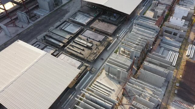Precast Concrete Wall Panels and Steel Supports Illustrate Early Industrial Construction within Modern Warehouse Setting Featuring Durable Precast Concrete Elements for Structural Support.