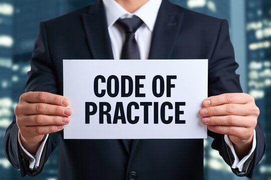 Male executive holding a white sheet of paper displaying code of practice against blurred city lights
