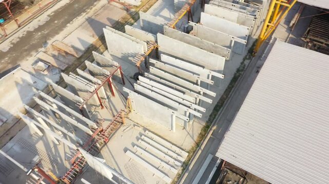 White Precast Concrete Wall Panels Being Constructed on Industrial Construction Site Featuring Corrugated Metal Roofing and Modern Building Materials for Commercial Projects, showcasing durable precas
