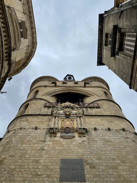 La Grosse Cloche medieval clock tower in Bordeaux from a narrow street perspective, France