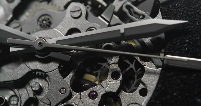 Macro close up of skeleton mechanical watch movement with dark dial and visible gears