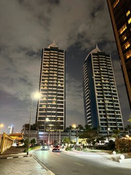 Night view of Atana Hotel twin towers and street traffic in Dubai, UAE, 16 March 2024
