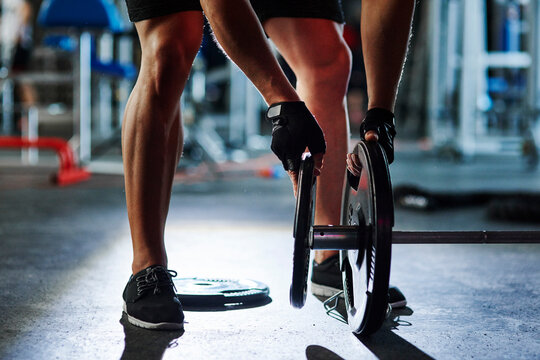 Man preparing barbell in gym