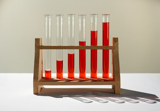 Ascending red liquid in a test tube rack showing growth
