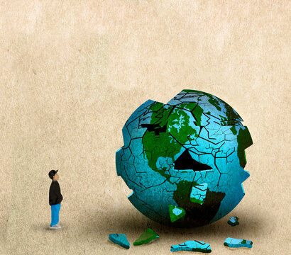 Little boy looking at planet Earth breaking down