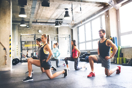Group of young people exercising in gym