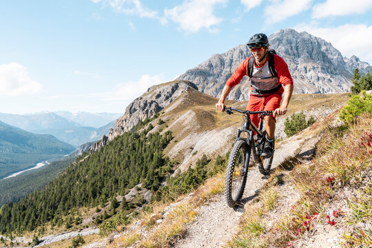 Man riding on mountainbike, Munestertal Valley, Grisons, Switzerland