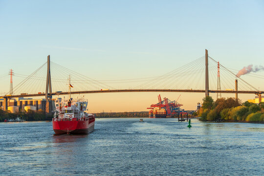 Red cargo ship under K�hlbrandbr�cke at Hamburg harbour