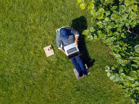 Man using laptop in garden