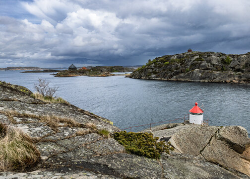 Abandoned Lifebuoy on Rocky Coastal Shore with Stormy Ocean Waves, Stavern, Norway